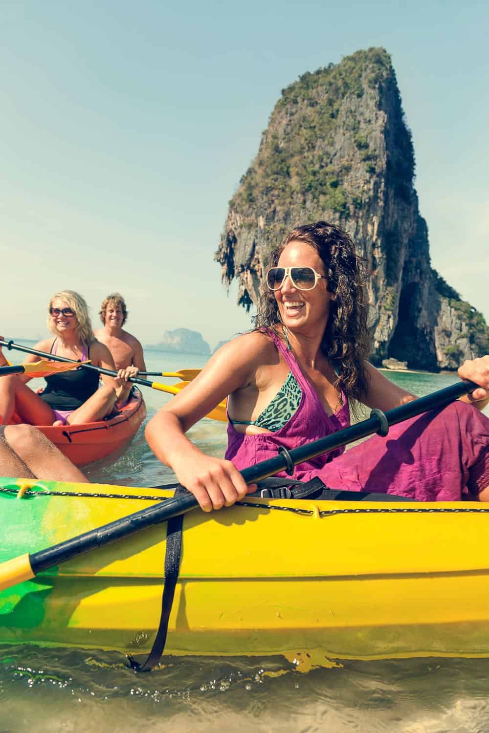 Kayaking in Thailand with limestone cliffs and clear waters, perfect for adventurous travel and exploring exotic destinations.
