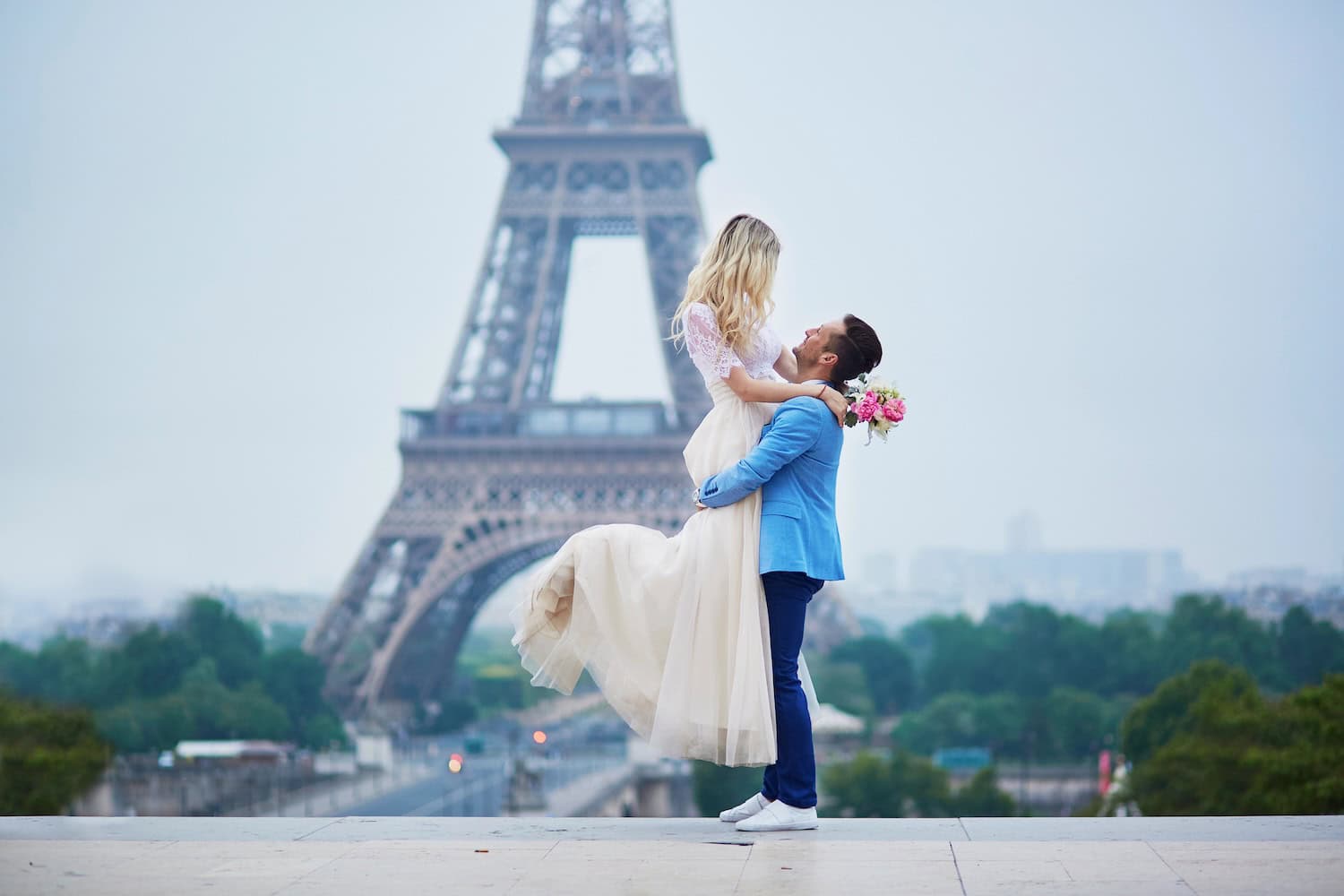 anniversaries-img-01 Elegant couple wedding photo in front of the Eiffel Tower, celebrating love and destination weddings in Paris, France. Perfect for romantic wedding destination concepts and Paris wedding planning.