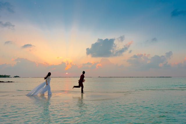 Romantic beach destination wedding photos at sunset.