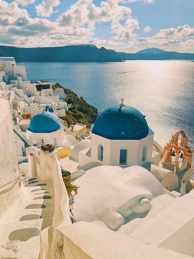 Santorini Greece travel destination with iconic white buildings and blue domes overlooking the Aegean Sea. Perfect for romantic getaways and scenic island vacations.