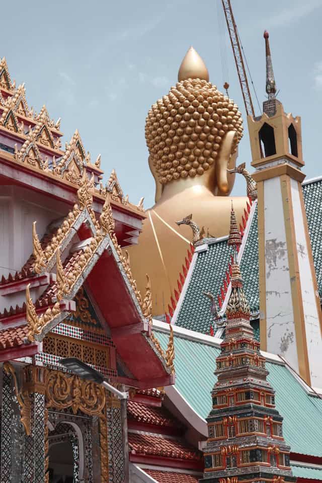 Golden Buddha head at Wat Pho temple in Bangkok Thailand, traditional Thai architecture, cultural landmark, travel destination, religious site.