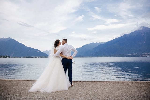 anniversaries-img-01 Romantic wedding couple by the lake with scenic mountain view, destination wedding photography.